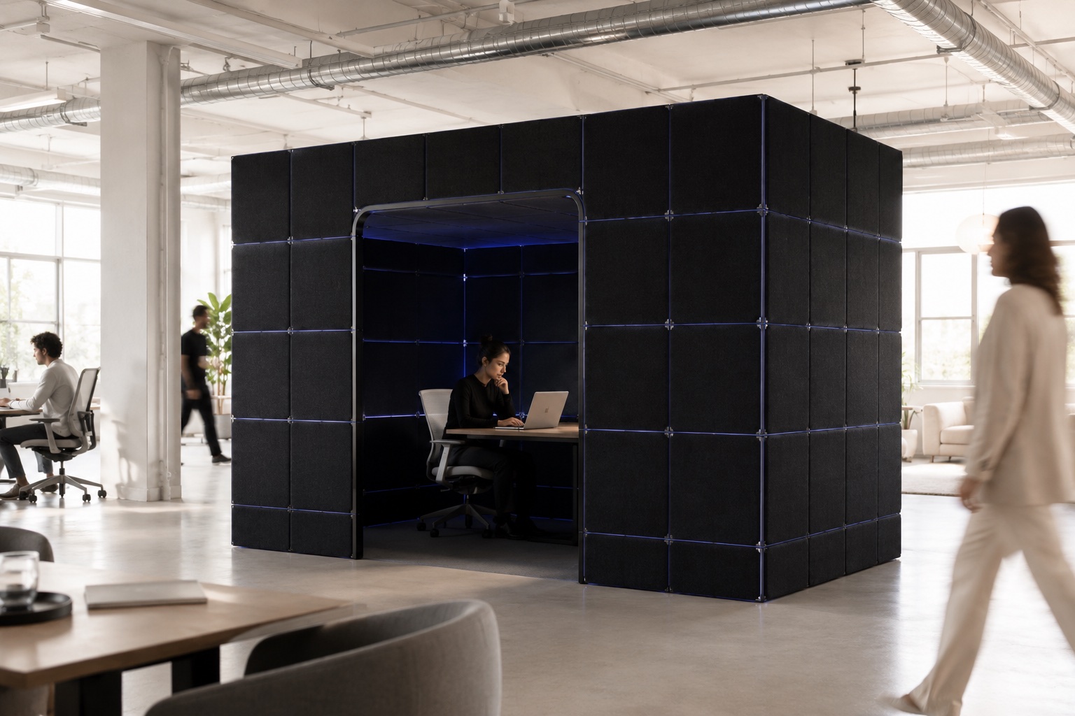 A Cognition full-tent pod enclosing a desk in a busy open-plan office, someone working calmly inside.